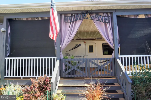 a view of a balcony with wooden floor and plants