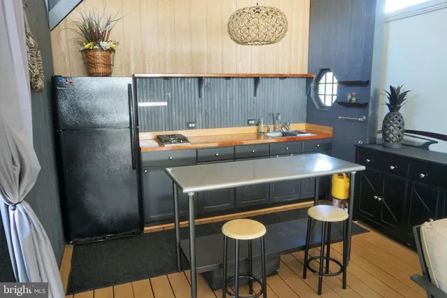 a kitchen with a table chairs and a stove top oven