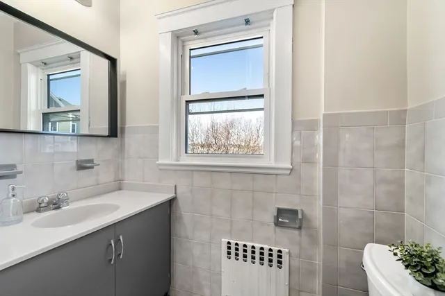 a bathroom with a sink mirror and window