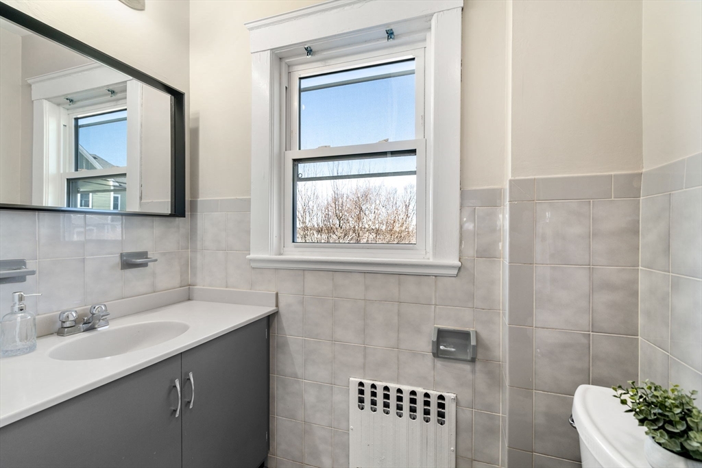 8 Charlesview Street, Unit 8 Boston, MA 02135 - Photo 12 of 12 a bathroom with a sink mirror and window