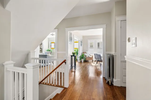 a view of entryway with wooden floor and livingroom view