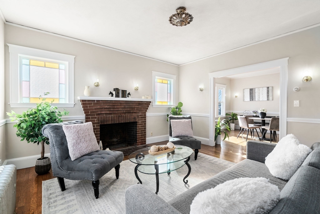 8 Charlesview Street, Unit 8 Boston, MA 02135 - Photo 4 of 12 a living room with furniture and a fireplace