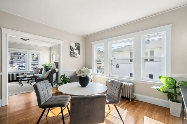 a view of a dining room with furniture and wooden floor
