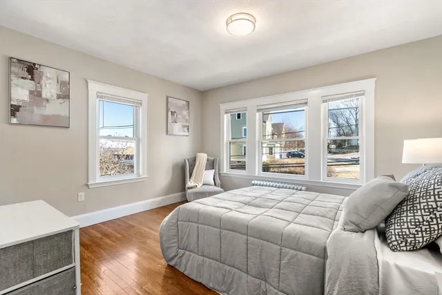 a bedroom with a large bed and a window