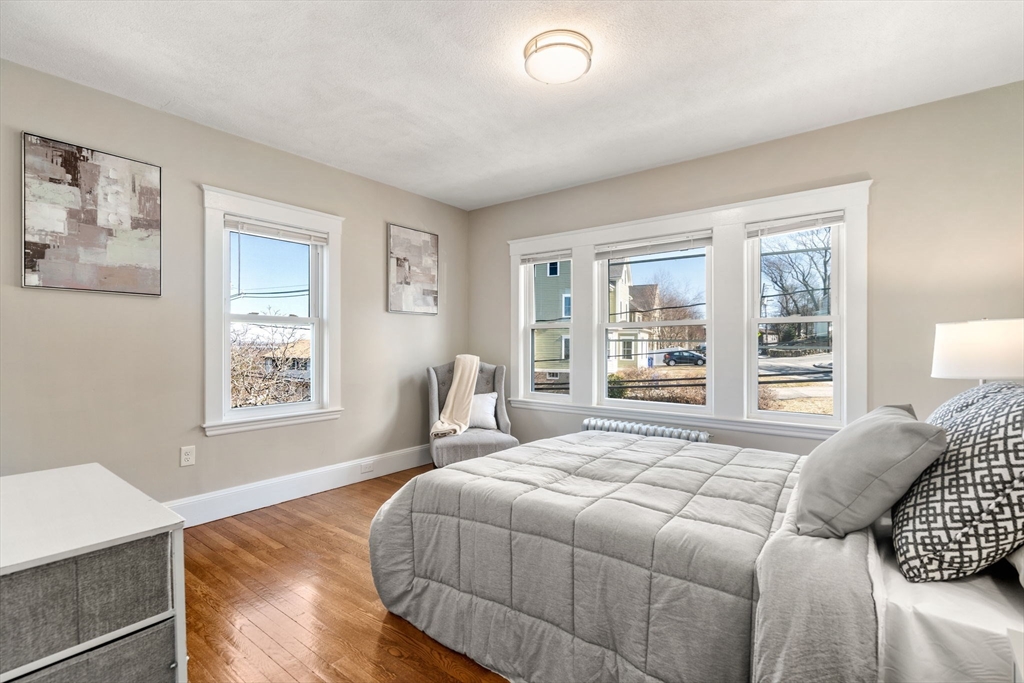 8 Charlesview Street, Unit 8 Boston, MA 02135 - Photo 7 of 12 a bedroom with a large bed and a window