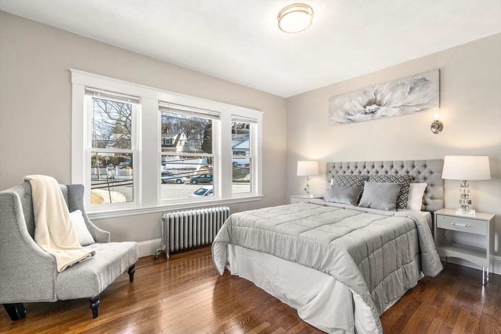 8 Charlesview Street, Unit 8 Boston, MA 02135 - Photo 8 of 12 a bedroom with a bed and a couch