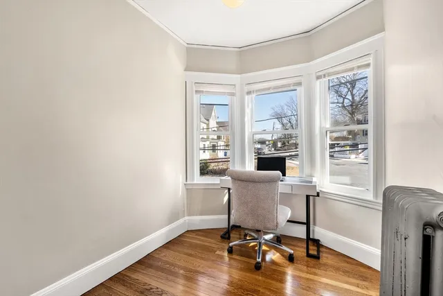 a view of a workspace with furniture and a window