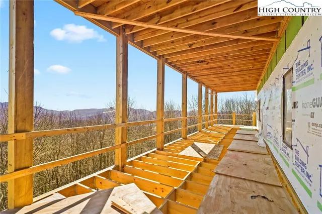 a view of a patio with table and chairs and wooden floor