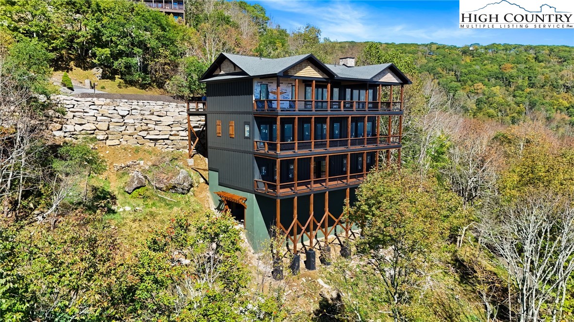 29 Fox Run Road Banner Elk, NC 28604 - Photo 3 of 47 a view of a brick house with large windows