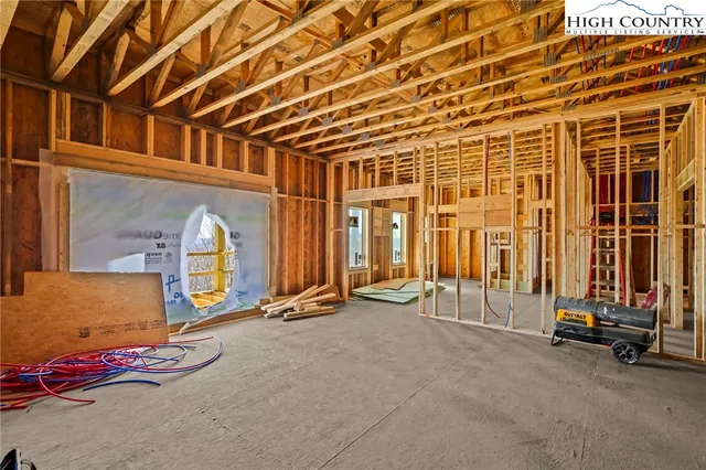 a view of staircase with railing and a window