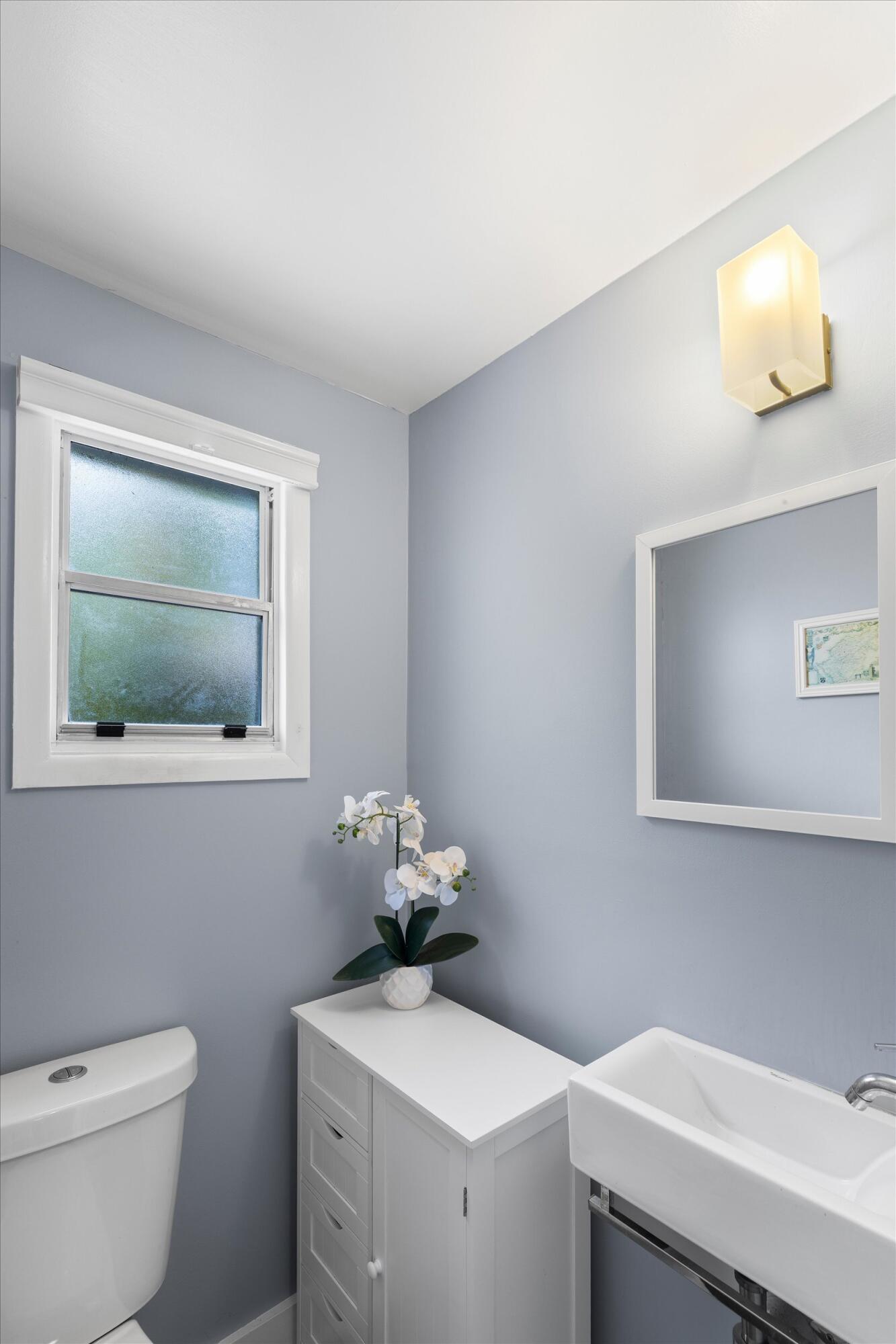 1507 19th Street Key West, FL 33040 - Photo 40 of 73 a bathroom with a toilet sink and mirror