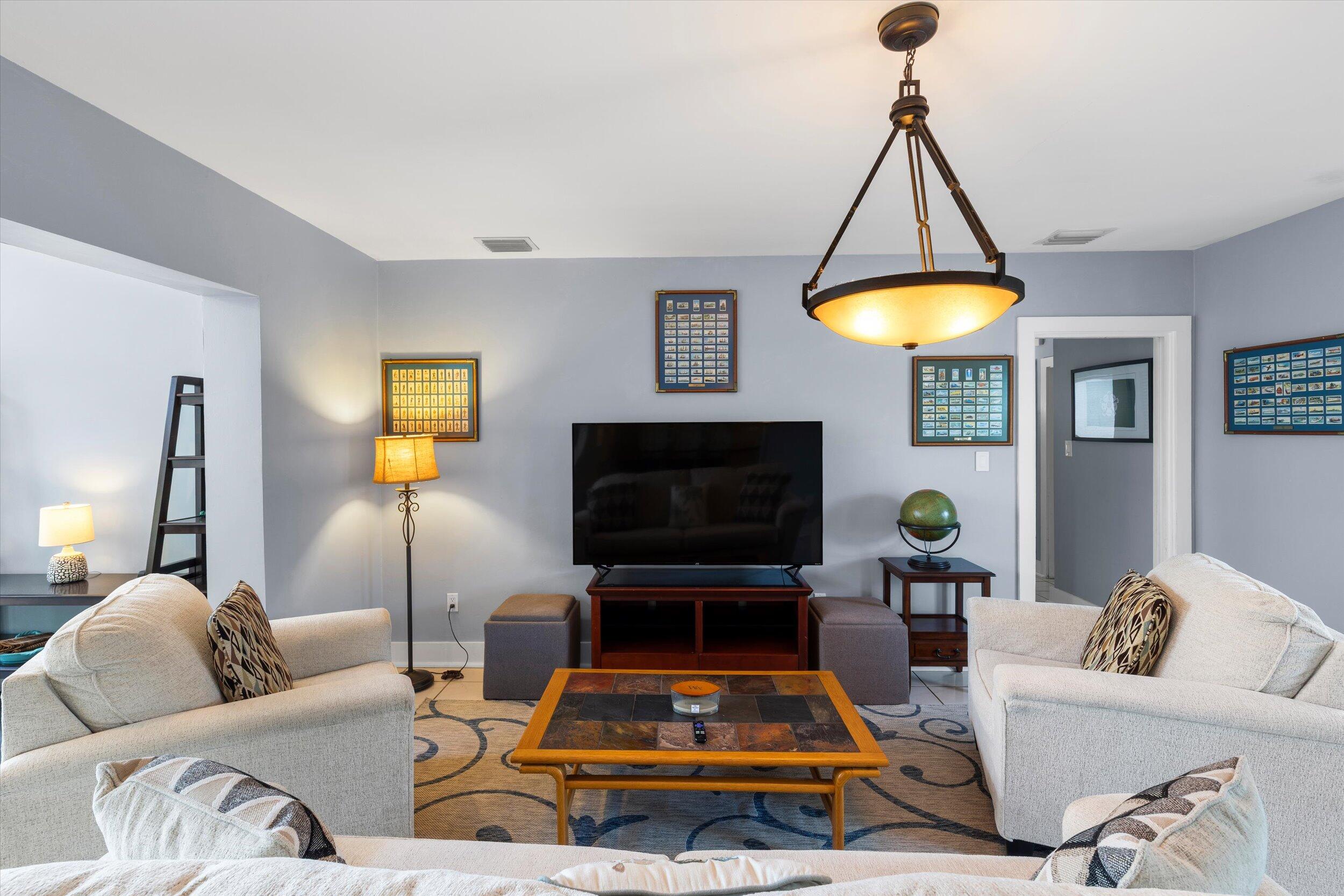 1507 19th Street Key West, FL 33040 - Photo 58 of 73 a living room with furniture a table and a flat screen tv