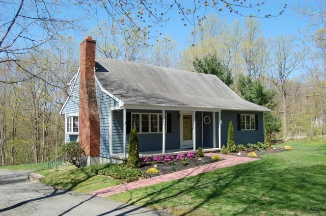 a view of a house with garden and porch