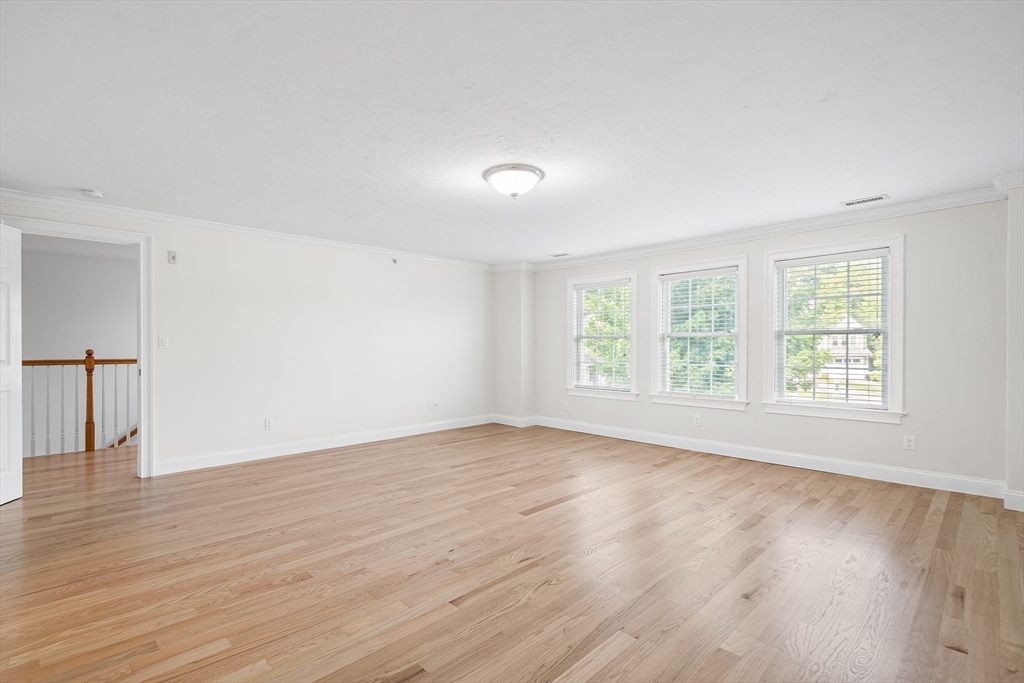 215 Rangeway Road, Unit 31 Billerica, MA 01862 - Photo 18 of 40 an empty room with wooden floor and windows