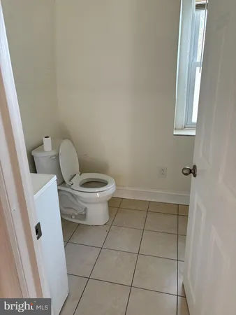 a bathroom with a toilet and a mirror