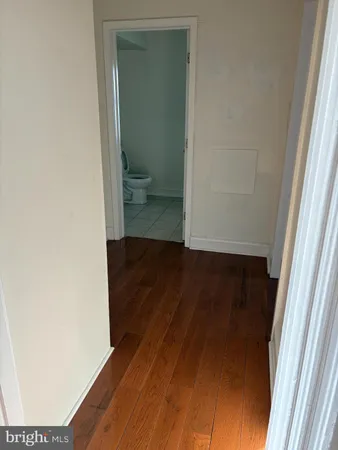 a view of a room with wooden floor