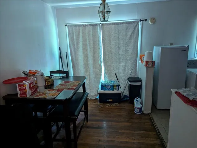 a dining room with furniture and wooden floor