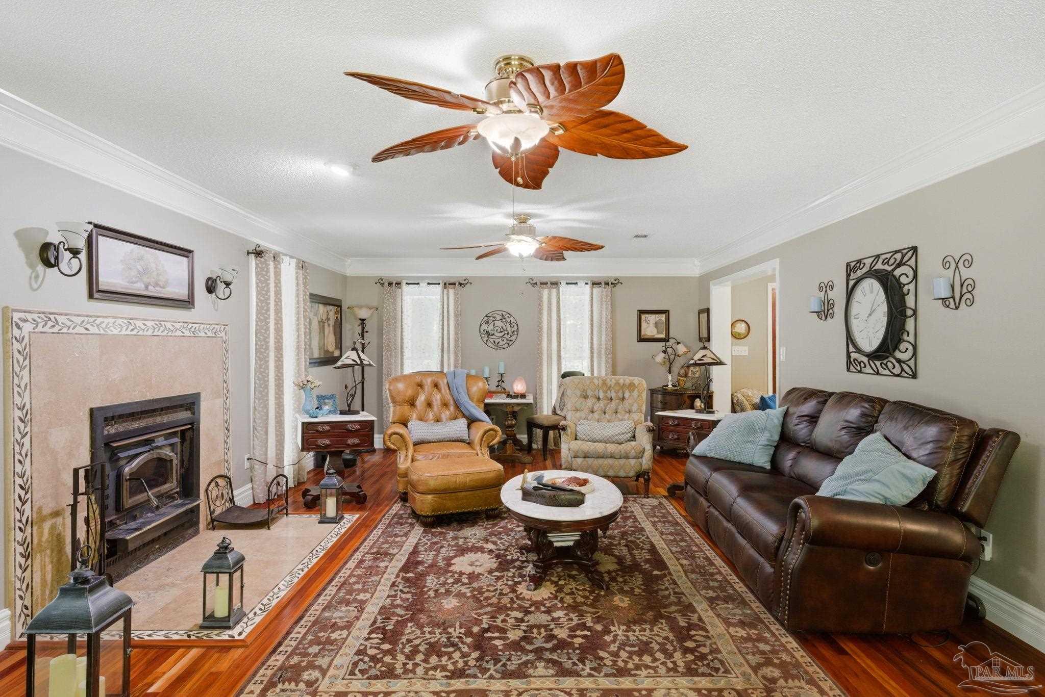 6930 Summit Way Milton, FL 32570 - Photo 11 of 71 a living room with furniture a fireplace and a flat screen tv