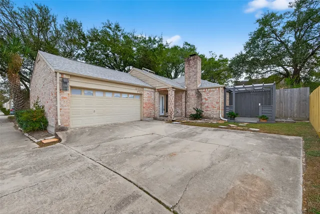 a view of a house with a yard and garage