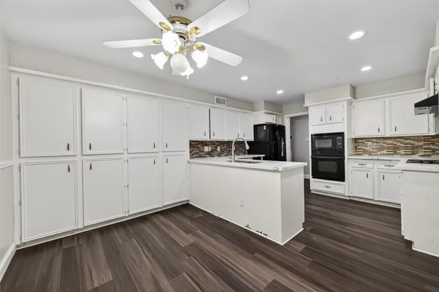 a view of kitchen with granite countertop cabinets and wooden floor