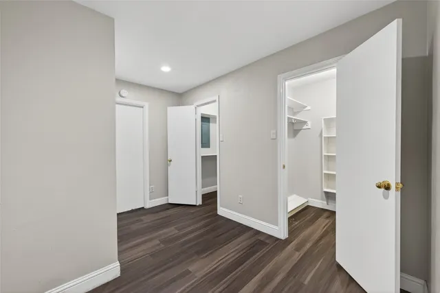 a view of hallway with wooden floor