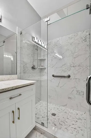 a bedroom with bed and paintings on the wall