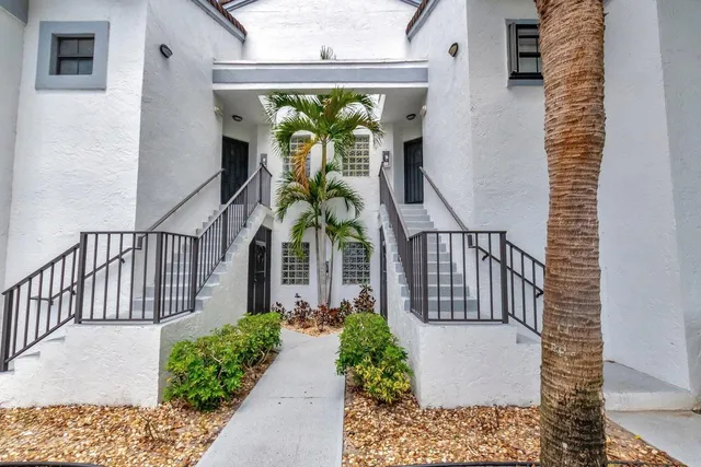 a view of a porch with potted plants