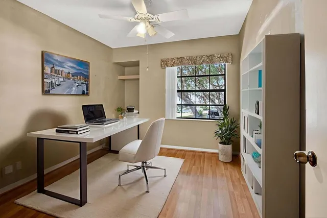 wooden floor in an empty room with a window