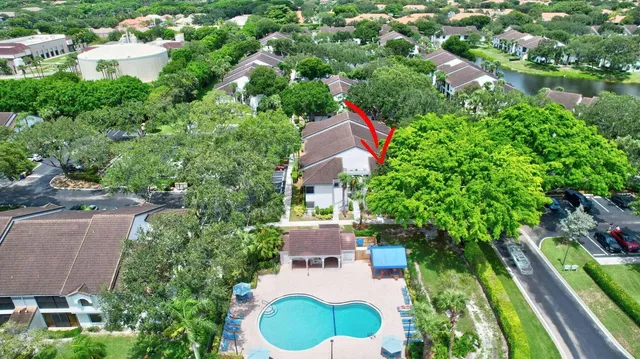 an aerial view of a house with swimming pool and outdoor seating