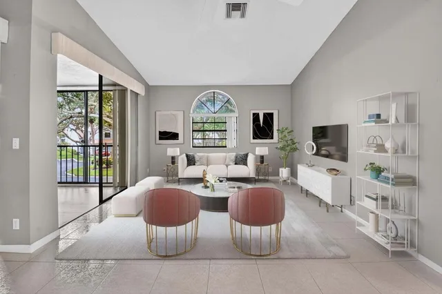 a living room with furniture a flat screen tv and a large window