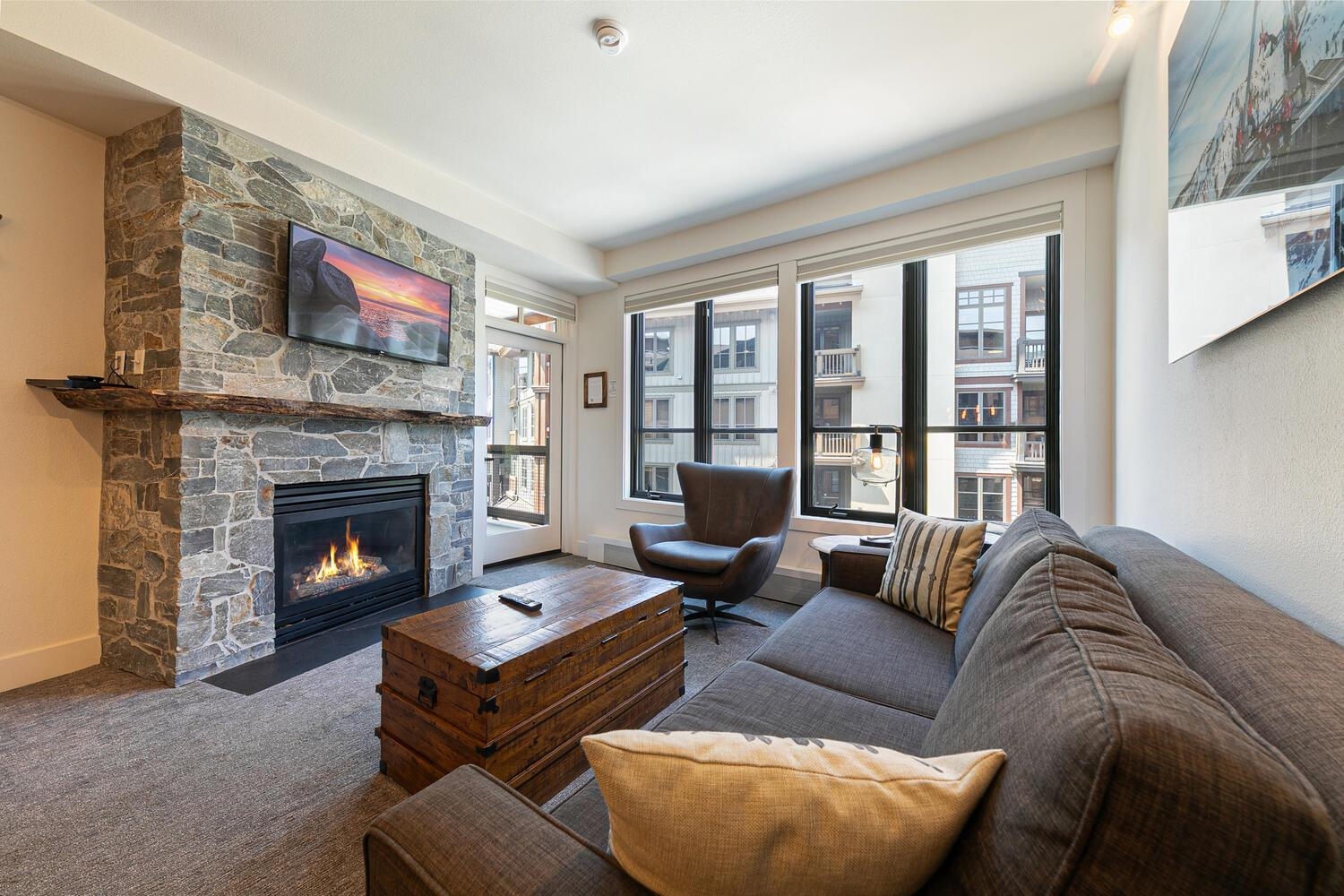 1750 Village East Road, Unit 5314 316 Olympic Valley, CA 96146 - Photo 7 of 28 a living room with furniture a large window and a fireplace