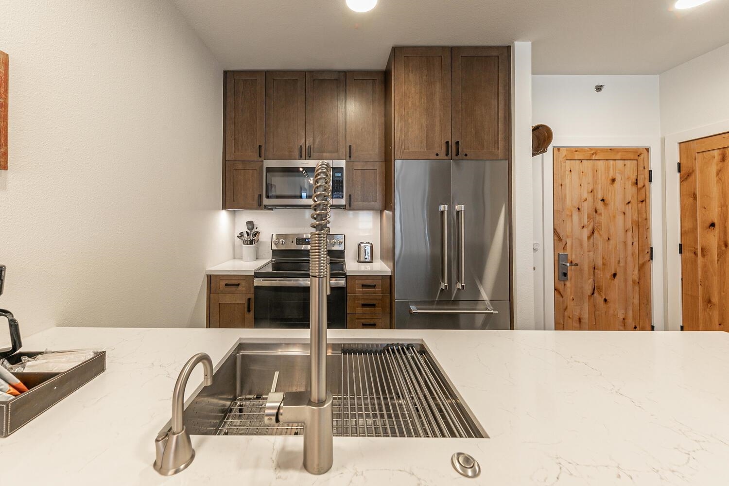 1750 Village East Road, Unit 5314 316 Olympic Valley, CA 96146 - Photo 9 of 28 a kitchen with stainless steel appliances kitchen island granite countertop a refrigerator and a sink