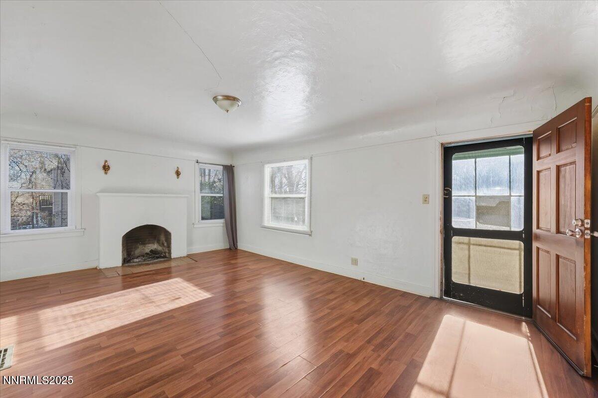 1140 The Strand Reno, NV 89503 - Photo 3 of 19 an empty room with windows and fireplace