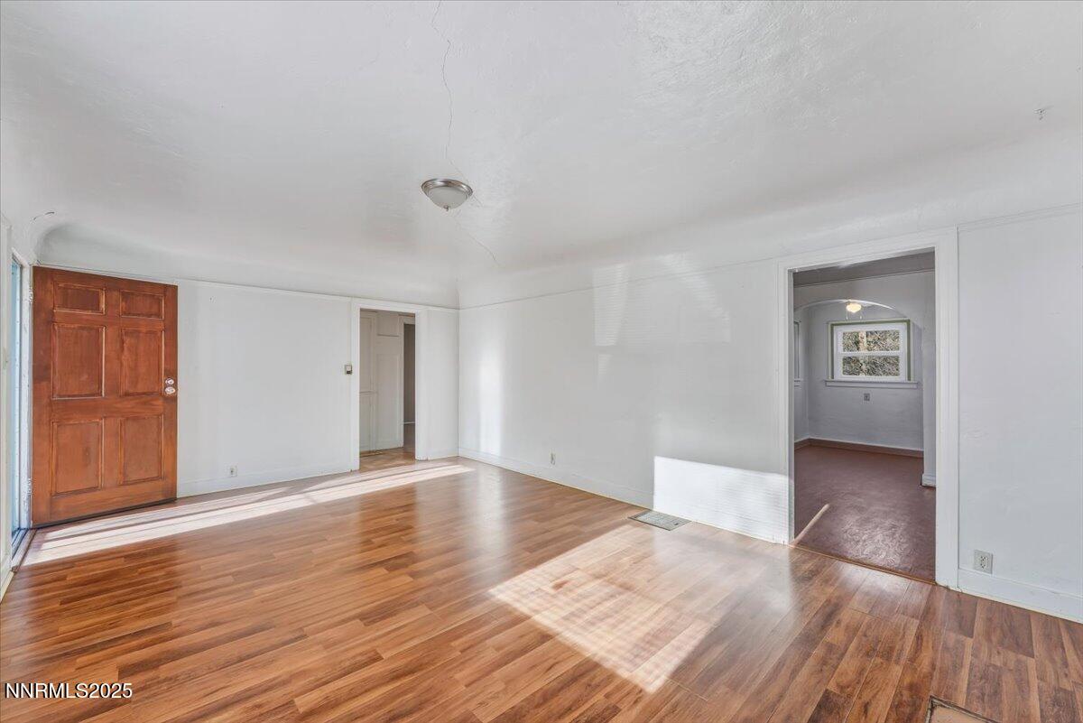 1140 The Strand Reno, NV 89503 - Photo 4 of 19 a view of an empty room with wooden floor and a window