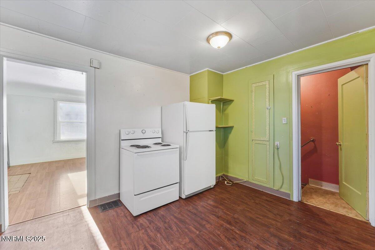 1140 The Strand Reno, NV 89503 - Photo 7 of 19 a view of a kitchen with a refrigerator wooden floor and a sink