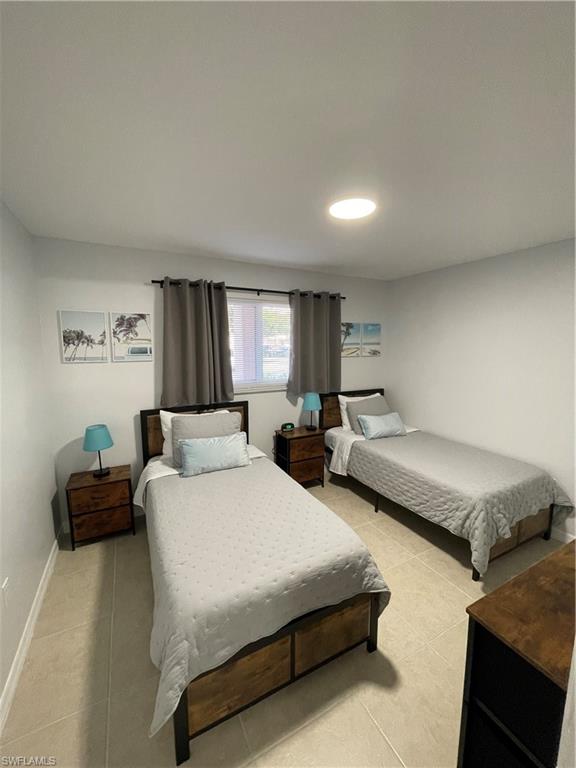 170 Turtle Lake Court, Unit 103 Naples, FL 34105 - Photo 21 of 37 Bedroom featuring light tile patterned floors and baseboards