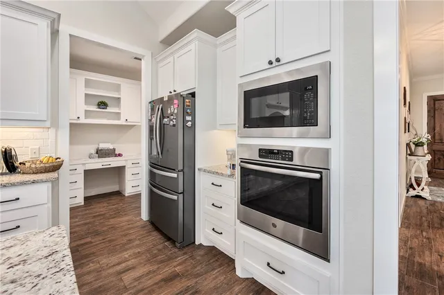 a kitchen with stainless steel appliances a stove a microwave and cabinets