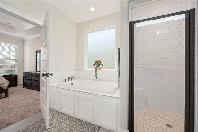 a bathroom with a granite countertop sink mirror and a bathtub