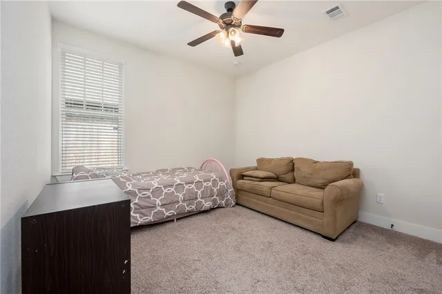 a view of walk in closet with clothes