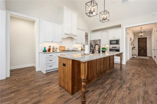 a kitchen with a sink cabinets and wooden floor
