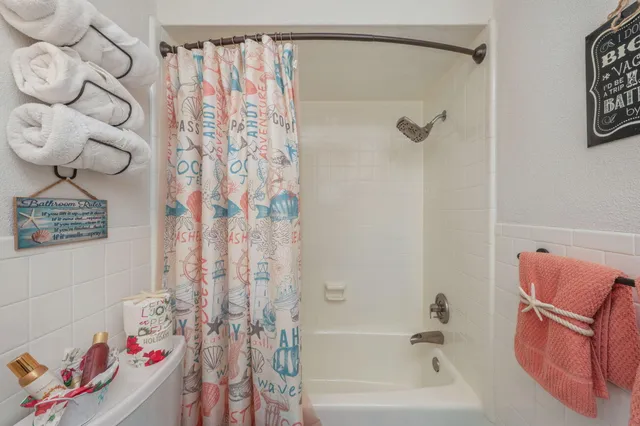 a bathroom with a shower curtain and a bathtub
