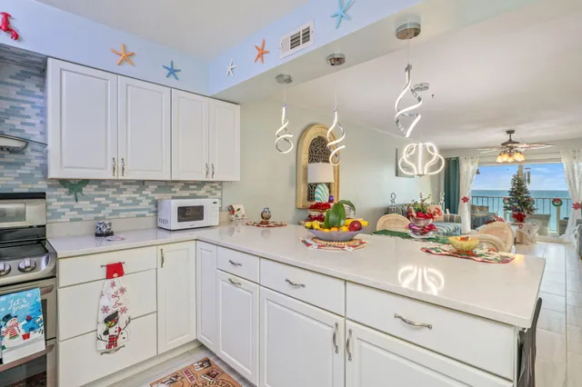 a view of a kitchen with cabinets and window