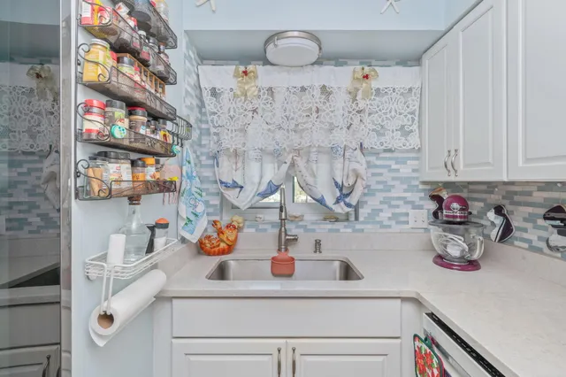 a kitchen with a sink and cabinets