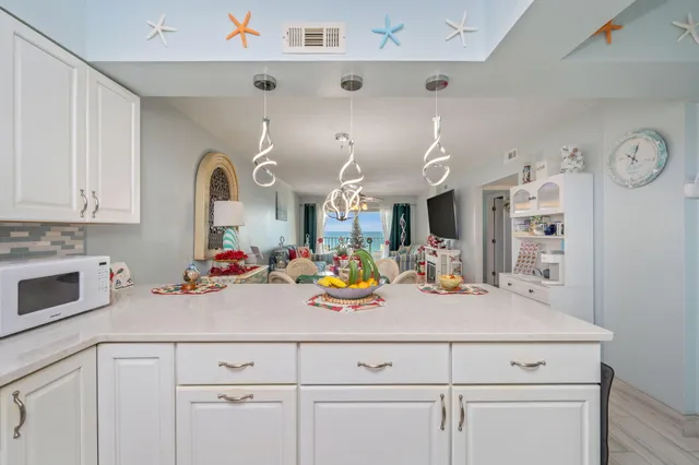 a kitchen with a sink a stove and cabinets