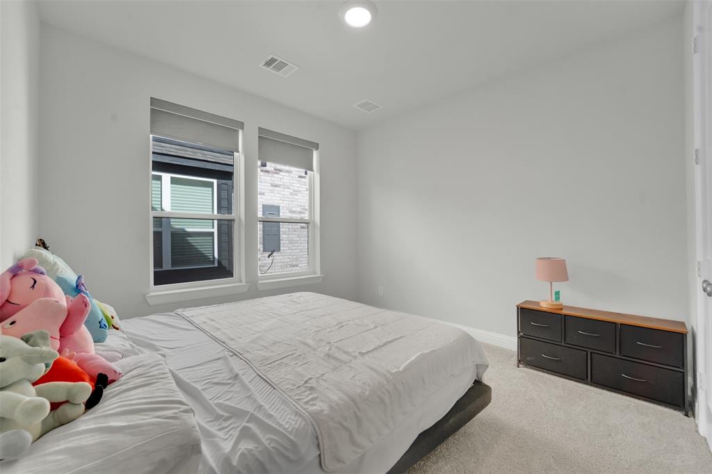 3520 Helios Lane Corinth, TX 76208 - Photo 24 of 37 Bright bedroom featuring light gray walls and plush carpeting