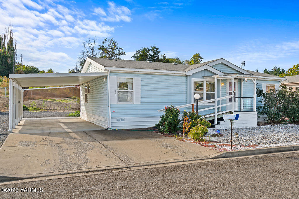 1200 South Euclid Road, Unit 99 Grandview, WA 98930 - Photo 1 of 22 a view of a house with a yard and potted plants