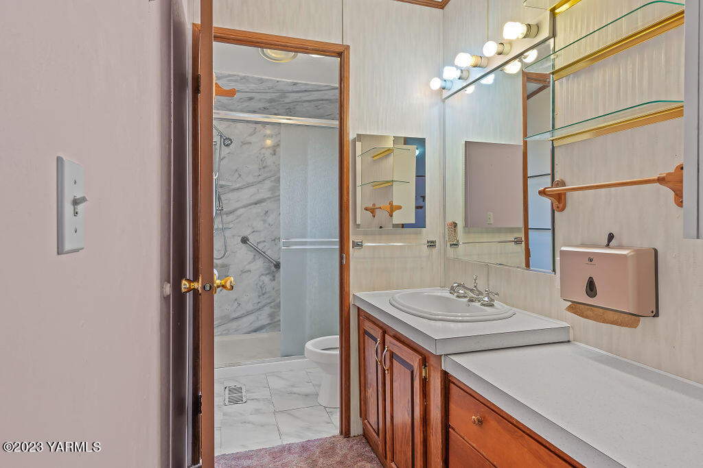1200 South Euclid Road, Unit 99 Grandview, WA 98930 - Photo 14 of 22 a bathroom with a sink a vanity and a mirror