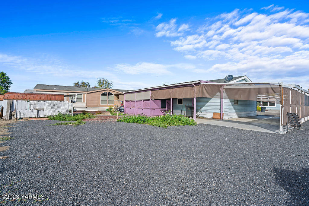 1200 South Euclid Road, Unit 99 Grandview, WA 98930 - Photo 22 of 22 a front view of a house with a yard and garage