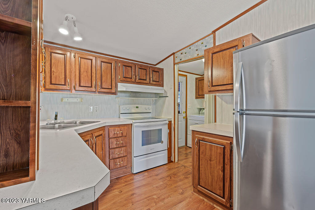 1200 South Euclid Road, Unit 99 Grandview, WA 98930 - Photo 10 of 22 a kitchen with stainless steel appliances granite countertop a refrigerator and a stove