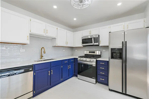 a kitchen with stainless steel appliances granite countertop a refrigerator stove a sink and dishwasher
